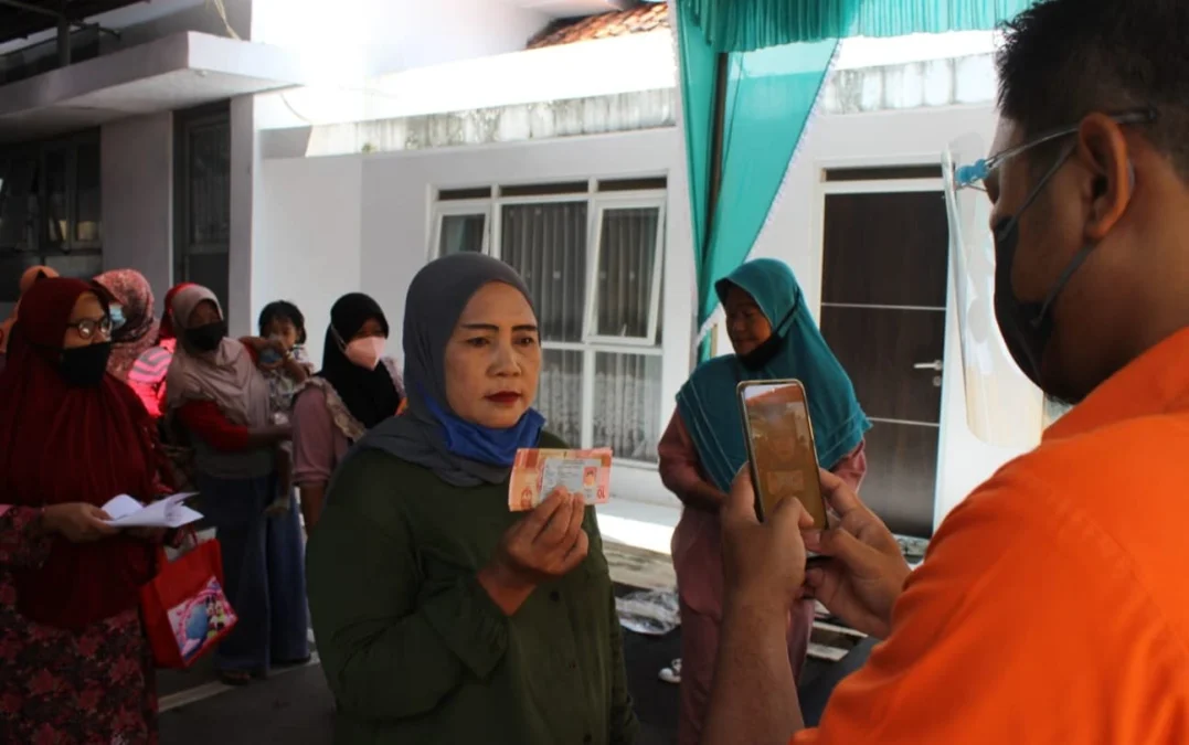 DIFOTO. Salah satu warga penerima BST didokumentasikan petugas setelah menerima bansos Program Sembako Tahap 1 tahun 2022 di Kantor Pos Indramayu. Bantuan disalurkan dalam bentuk uang tunai untuk tiga bulan sekaligus.