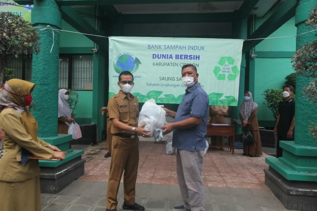 KOMITMEN BERSAMA. Kadis LH, Iwan Ridwan Hardiawan menerima sampah non organik dari komunitas Bank Sampah.