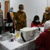 MONITORING. Bupati Cirebon, H Imron bersama Wabup, Hj Wahyu Tjiptaningsih dan Kapolresta Cirebon melihat proses vaksinasi massal, kemarin.