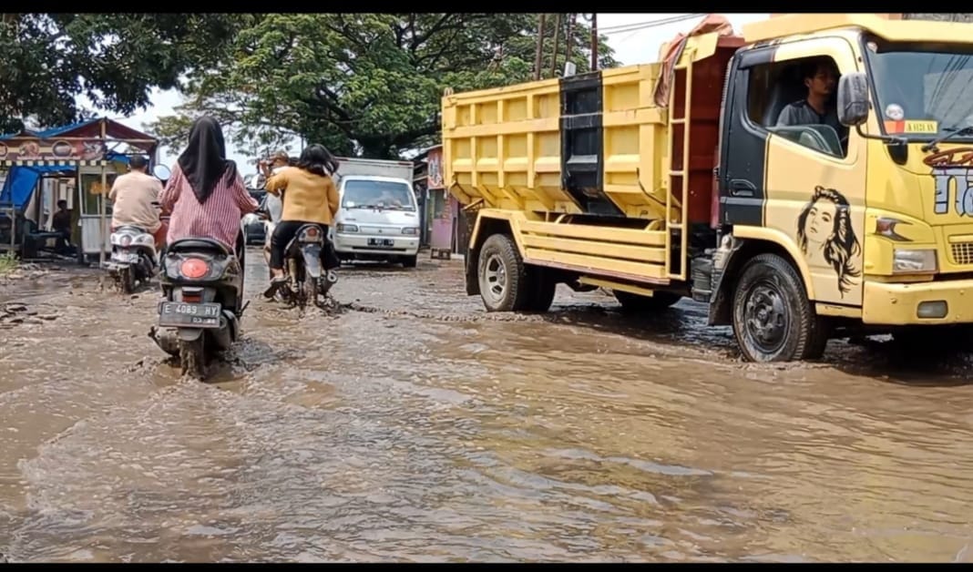 PERLU PERHATIAN. Kondisi jalan rusak dan dipenuhi genangan air pasca hujan lebat.